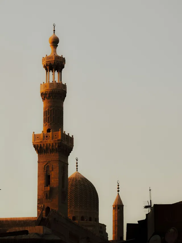 A Cairo minaret and dome in warm evening light